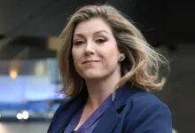 Penny Mordaunt carrying the Sword of State at King Charles III’s coronation, symbolizing her pivotal role in British politics.