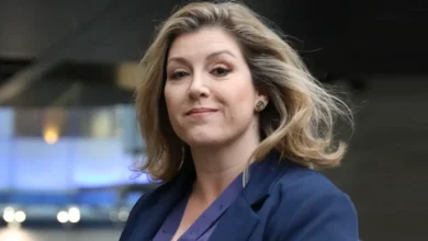 Penny Mordaunt carrying the Sword of State at King Charles III’s coronation, symbolizing her pivotal role in British politics.