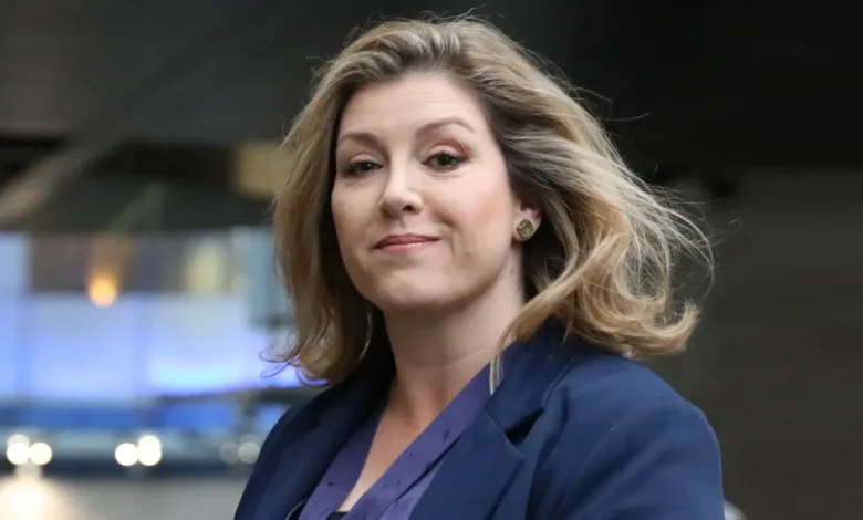 Penny Mordaunt carrying the Sword of State at King Charles III’s coronation, symbolizing her pivotal role in British politics.