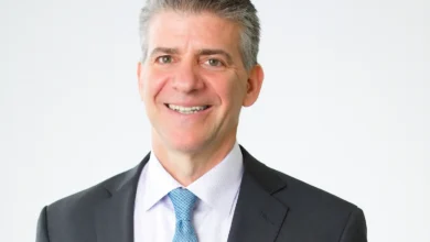 Allan Bruce Rothschild and Kitt Shapiro on their wedding day in 2002, smiling softly in formal attire with Eartha Kitt looking on proudly – symbolizing enduring love and legacy.